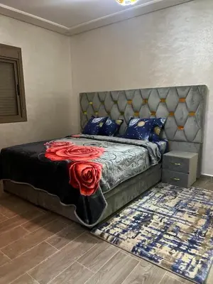 a bedroom with a bed with red roses on it at Hote othmane in Beni Mellal