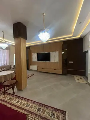 a living room with a flat screen tv and a couch at Campagne & Confort only family in El Hajeb
