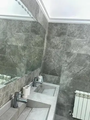 a bathroom with two sinks and a shower at Campagne & Confort only family in El Hajeb