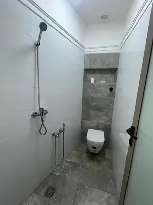 a bathroom with a toilet and a shower stall at Campagne & Confort only family in El Hajeb