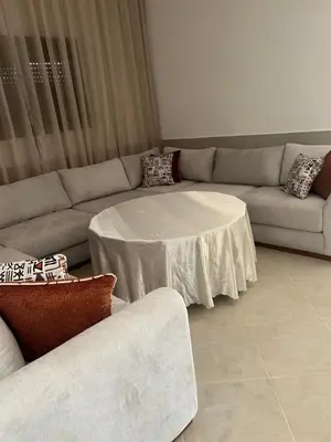 a living room with a couch and a table at Campagne & Confort only family in El Hajeb