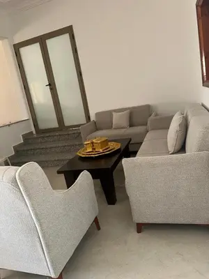a living room with two couches and a coffee table at Campagne & Confort only family in El Hajeb