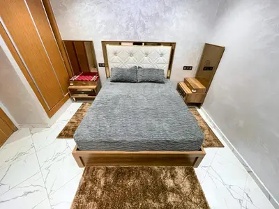 a bedroom with two beds and two night stands at 2BR Luxurious Apartment - 2 Min from City Center in Fès