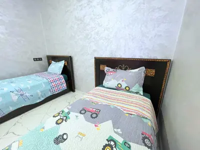 a bedroom with a bed with a truck bed at 2BR Luxurious Apartment - 2 Min from City Center in Fès