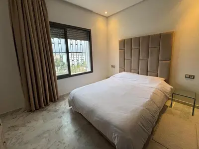 a bedroom with a large bed and a window at Luxury 3-Bedroom Apartment Near Marriott Fès in Fès
