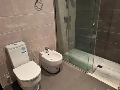 a bathroom with a toilet and a shower at Luxury 3-Bedroom Apartment Near Marriott Fès in Fès