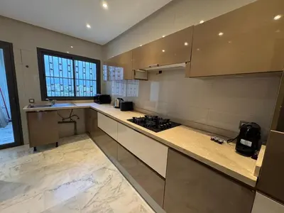 a kitchen with a stove and a counter top at Luxury 3-Bedroom Apartment Near Marriott Fès in Fès