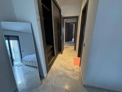 a hallway with mirrors and a bed in a room at Luxury 3-Bedroom Apartment Near Marriott Fès in Fès