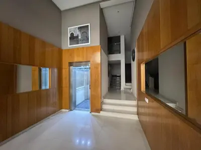 a hallway with wooden walls and a hallway with a door at Luxury 3-Bedroom Apartment Near Marriott Fès in Fès
