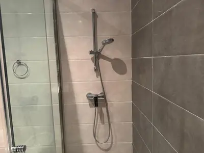 a shower with a shower head in a bathroom at Luxury 3-Bedroom Apartment Near Marriott Fès in Fès