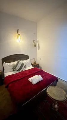 a bedroom with a bed with two towels on it at Riad fezira in Fès