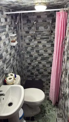 a bathroom with a toilet and a sink and a shower at Riad fezira in Fès