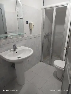 a bathroom with a sink and a shower and a toilet at Black iris tadamoune in Meknès