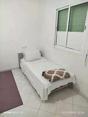 a room with a bed with a giraffe blanket on it at Black iris tadamoune in Meknès