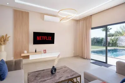 a living room with a couch and a table at Bali family villa 0 vis-à-vis in Chouiter