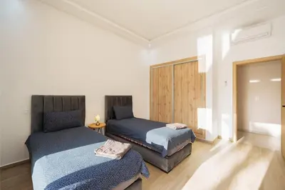 a bedroom with two beds in a room at Bali family villa 0 vis-à-vis in Chouiter