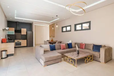 a living room with a couch and a table at Bali family villa 0 vis-à-vis in Chouiter