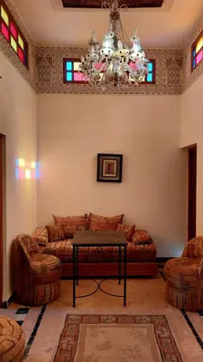 a living room with a couch and a chandelier at JNANE RBATI Apartement in Fès