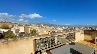 a view of a city from the balcony of a building at JNANE RBATI Apartement in Fès