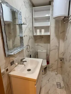 a bathroom with a sink and a toilet at Gueliz Twin Balcony Apartment F3 in Oulad Akkou