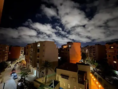 a view of a city at night at Gueliz Twin Balcony Apartment F3 in Oulad Akkou