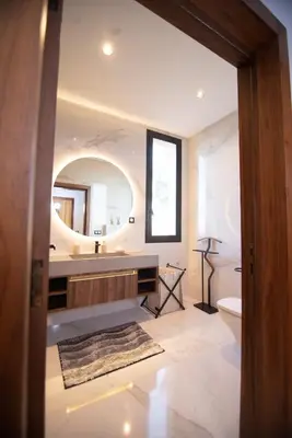 a bathroom with a sink and a toilet and a mirror at Somptueuse villa 10personnes in Najem