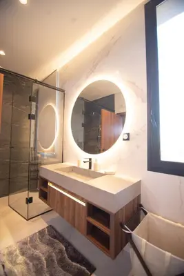 a bathroom with a sink and a mirror at Somptueuse villa 10personnes in Najem