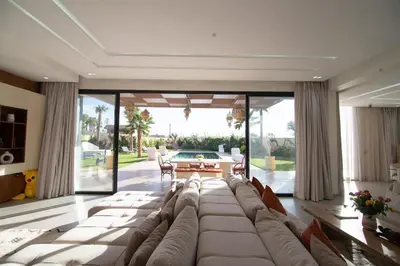 a living room with a large couch and a table at Somptueuse villa 10personnes in Najem