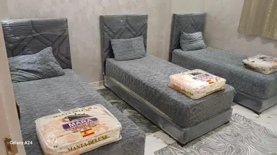 a room with three beds with mattresses on them at شقق الراحة in Oulad Akkou