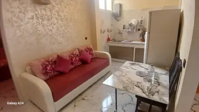 a living room with a couch and a table at شقق الراحة in Oulad Akkou