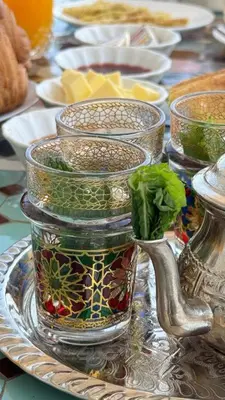 a table with several glass vases on a plate at Fes flower in Fès