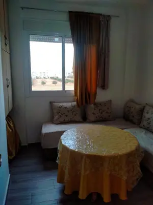 a small room with a table and a window at Apartment with Elevator Stadium and CHU within walking distance in Fès