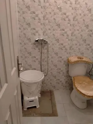 a bathroom with a toilet and a shower in it at Apartment with Elevator Stadium and CHU within walking distance in Fès