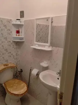a bathroom with a toilet and a sink at Apartment with Elevator Stadium and CHU within walking distance in Fès
