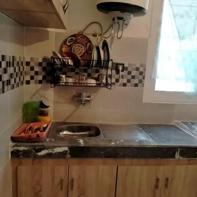 a kitchen counter with a sink and a window at Apartment with Elevator Stadium and CHU within walking distance in Fès
