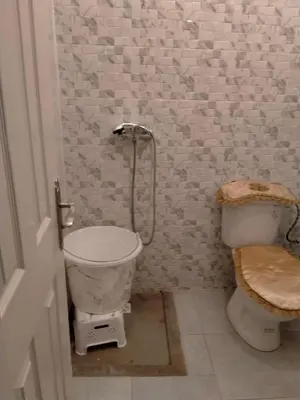 a bathroom with a toilet and a shower in it at Apartment with Elevator Stadium and CHU within walking distance in Fès
