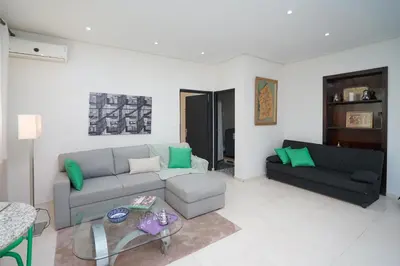 a living room with a couch and a table at Luxury Fes Residence Appartement & Studio in Fès