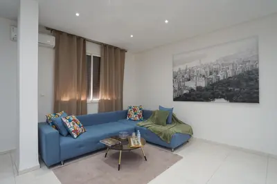 a living room with a blue couch and a table at Luxury Fes Residence Appartement & Studio in Fès
