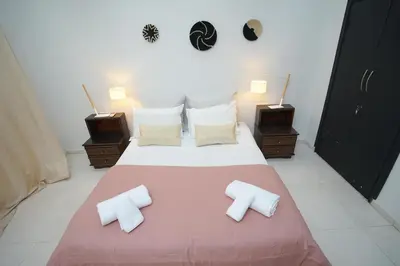 a bedroom with a large bed with two pillows at Luxury Fes Residence Appartement & Studio in Fès