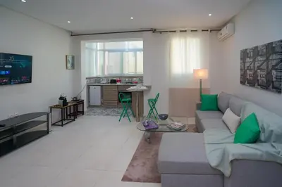 a living room with a couch and a table at Luxury Fes Residence Appartement & Studio in Fès