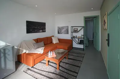 a living room with an orange couch and a coffee table at Luxury Fes Residence Appartement & Studio in Fès
