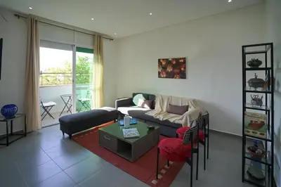 a living room with a couch and a table at Luxury Fes Residence Appartement & Studio in Fès