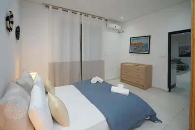 a bedroom with a bed with two towels on it at Luxury Fes Residence Appartement & Studio in Fès