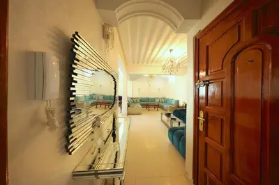 a hallway with a room with couches and a door at Apparemment de vacances centre de fes in Fès