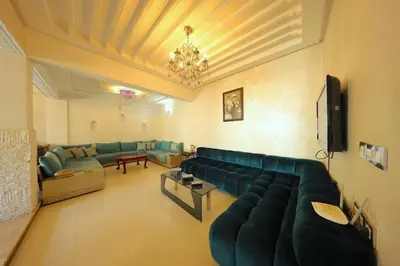 a living room with a couch and a tv at Apparemment de vacances centre de fes in Fès