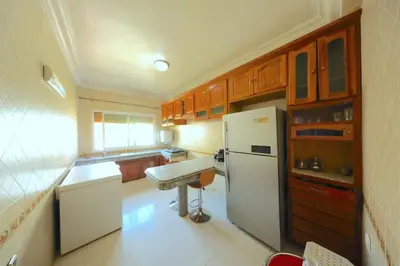 a kitchen with a white refrigerator and a sink at Apparemment de vacances centre de fes in Fès