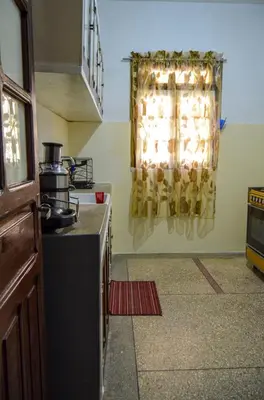 a kitchen with a stove and a window at dar sara medina fes in Fès