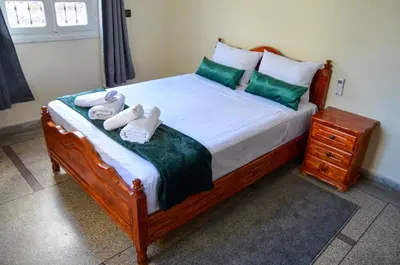 a bed with green and white towels on it at dar sara medina fes in Fès