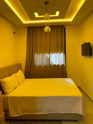 a yellow bedroom with a bed with a window at Dar aya in Beni Mellal