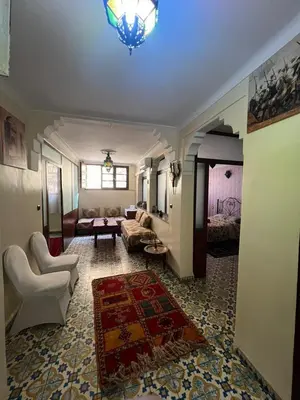 a living room with a couch and a living room with a rug at Appartement Old Medina fes in Fès